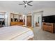 Bedroom with carpet, ceiling fan, wood furniture, closet and archway to another room at 13804 W 61St Cir, Arvada, CO 80004