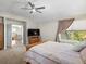 Bright bedroom featuring a ceiling fan, natural light, and an open door to the landing at 13804 W 61St Cir, Arvada, CO 80004