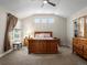 Bright bedroom with three transom windows, ceiling fan, wood furniture and neutral carpet at 13804 W 61St Cir, Arvada, CO 80004