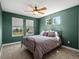 Calming bedroom featuring two bright windows, a ceiling fan and an iron bedframe at 13804 W 61St Cir, Arvada, CO 80004
