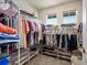 Walk-in closet with organized shelving, rods and storage for clothing and shoes with two windows at 13804 W 61St Cir, Arvada, CO 80004