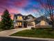 Charming two-story home featuring a well-manicured lawn and attached two-car garage at 13804 W 61St Cir, Arvada, CO 80004