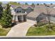 Charming two-story home featuring a well-manicured lawn, covered porch, and attached two-car garage at 13804 W 61St Cir, Arvada, CO 80004