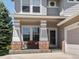 Inviting covered front porch featuring a cozy bench and decorative details at 13804 W 61St Cir, Arvada, CO 80004