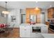 Spacious kitchen boasts stainless steel appliances, quartz counters, and wood floors at 13804 W 61St Cir, Arvada, CO 80004