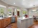 Bright kitchen features wooden cabinets, stainless steel appliances, a center island, and an open floor plan at 13804 W 61St Cir, Arvada, CO 80004
