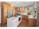 Well-lit kitchen with stainless steel appliances, white island, and warm-toned cabinets at 13804 W 61St Cir, Arvada, CO 80004