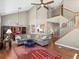 Spacious living room with high ceilings, open staircase, and hardwood floors at 13804 W 61St Cir, Arvada, CO 80004