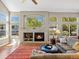 Comfortable living room boasts a fireplace, large windows, and hardwood floors at 13804 W 61St Cir, Arvada, CO 80004