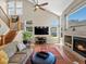 Bright living room featuring a fireplace, large windows, hardwood floors, and open staircase at 13804 W 61St Cir, Arvada, CO 80004