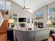 Spacious living room with vaulted ceilings, fireplace, and staircase at 13804 W 61St Cir, Arvada, CO 80004