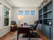 Well-lit home office featuring built-in bookshelves and a comfortable workspace at 13804 W 61St Cir, Arvada, CO 80004