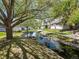 Scenic community pond with lush landscaping, rock features, and townhome views at 13804 W 61St Cir, Arvada, CO 80004
