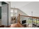 Open staircase with wrought iron railing leading to the living area with large windows and ample light at 13804 W 61St Cir, Arvada, CO 80004