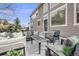 Back exterior of home with a stone patio featuring outdoor furniture at 7329 Arco Iris Ln, Castle Pines, CO 80108