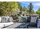 Inviting outdoor patio featuring comfortable seating and lush landscaping at 7329 Arco Iris Ln, Castle Pines, CO 80108