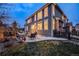 Back exterior of home with a stone patio featuring outdoor furniture at 7329 Arco Iris Ln, Castle Pines, CO 80108