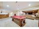 Finished basement with a bar area, pool table, and living room area with TV at 7329 Arco Iris Ln, Castle Pines, CO 80108