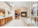 Bathroom features a fireplace between the tub and bedroom, with dual sinks at 7329 Arco Iris Ln, Castle Pines, CO 80108