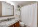 Cozy bathroom featuring granite countertops and a shower with a curtain at 7329 Arco Iris Ln, Castle Pines, CO 80108