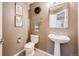Stylish half-bathroom with pedestal sink and tasteful decorations at 7329 Arco Iris Ln, Castle Pines, CO 80108