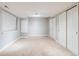 Neutral bedroom with a large window, closet space and neutral carpeting at 7329 Arco Iris Ln, Castle Pines, CO 80108