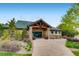 Community clubhouse with stone pillars and lush, green landscaping at 7329 Arco Iris Ln, Castle Pines, CO 80108