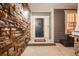Inviting front entryway with a stone accent wall and a welcoming blue door with decorative wreath at 7329 Arco Iris Ln, Castle Pines, CO 80108