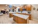 Modern kitchen with a center island, granite countertops, wooden cabinets, and stainless steel appliances at 7329 Arco Iris Ln, Castle Pines, CO 80108