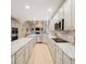 Bright kitchen features stainless appliances, granite countertops, and ample cabinet space at 7329 Arco Iris Ln, Castle Pines, CO 80108