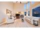 Spacious living room with high ceilings, fireplace, and plenty of natural light at 7329 Arco Iris Ln, Castle Pines, CO 80108