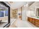 Main bathroom featuring a soaking tub, glass shower, and double vanity at 7329 Arco Iris Ln, Castle Pines, CO 80108