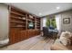 Well-lit home office with built-in bookshelves and a comfortable workspace at 7329 Arco Iris Ln, Castle Pines, CO 80108