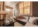Cozy outdoor patio featuring comfortable seating, a fire table, and views of the front entrance at 7329 Arco Iris Ln, Castle Pines, CO 80108