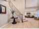 Elegant foyer showcasing a curved staircase with wrought iron railings and hardwood floors, creating a stunning focal point at 7329 Arco Iris Ln, Castle Pines, CO 80108