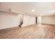 Expansive finished basement with wood-look flooring, recessed lighting, and staircase, providing ample space at 1048 N Columbine St, Golden, CO 80403