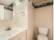 Cozy half-bathroom featuring a toilet, sink with vanity, and decorative wallpaper border at 1048 N Columbine St, Golden, CO 80403