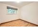 Well-lit bedroom with hardwood floors, neutral walls, and a large window at 1048 N Columbine St, Golden, CO 80403