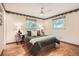 Serene bedroom with two windows, hardwood floors, and soft, inviting bedding at 1048 N Columbine St, Golden, CO 80403