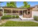 Inviting brick home with covered front porch featuring a swing, decorative brickwork, and manicured landscaping at 1048 N Columbine St, Golden, CO 80403
