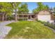 Charming brick home with a manicured lawn and covered front porch in a well-landscaped yard at 1048 N Columbine St, Golden, CO 80403
