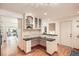 Functional kitchen area with built-in desk, glass cabinets, and wood floors in a neutrally decorated space at 1048 N Columbine St, Golden, CO 80403