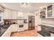 Bright kitchen with white cabinets, stainless steel appliances, granite countertops, and hardwood floors at 1048 N Columbine St, Golden, CO 80403