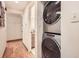 Efficient laundry area featuring stacked washer and dryer near an adjacent bathroom with wood-look flooring at 1048 N Columbine St, Golden, CO 80403