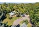 Aerial view of property featuring circular driveway surrounded by mature trees on a sunny day at 8813 Baseline Rd, Lafayette, CO 80026
