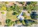 Aerial view of the residence showcasing a large front yard, circle driveway, and abundant mature trees at 8813 Baseline Rd, Lafayette, CO 80026