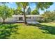 Backyard of home featuring a large deck, well-maintained lawn, and mature trees at 8813 Baseline Rd, Lafayette, CO 80026