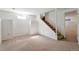 Open basement space with carpet and stairs leading to another floor at 8813 Baseline Rd, Lafayette, CO 80026