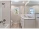 Bright bathroom featuring a double sink vanity with a marble countertop and a shower over tub at 8813 Baseline Rd, Lafayette, CO 80026