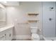 Modern bathroom features a walk-in shower, floating shelves, new fixtures, and a stylish vanity with good lighting at 8813 Baseline Rd, Lafayette, CO 80026